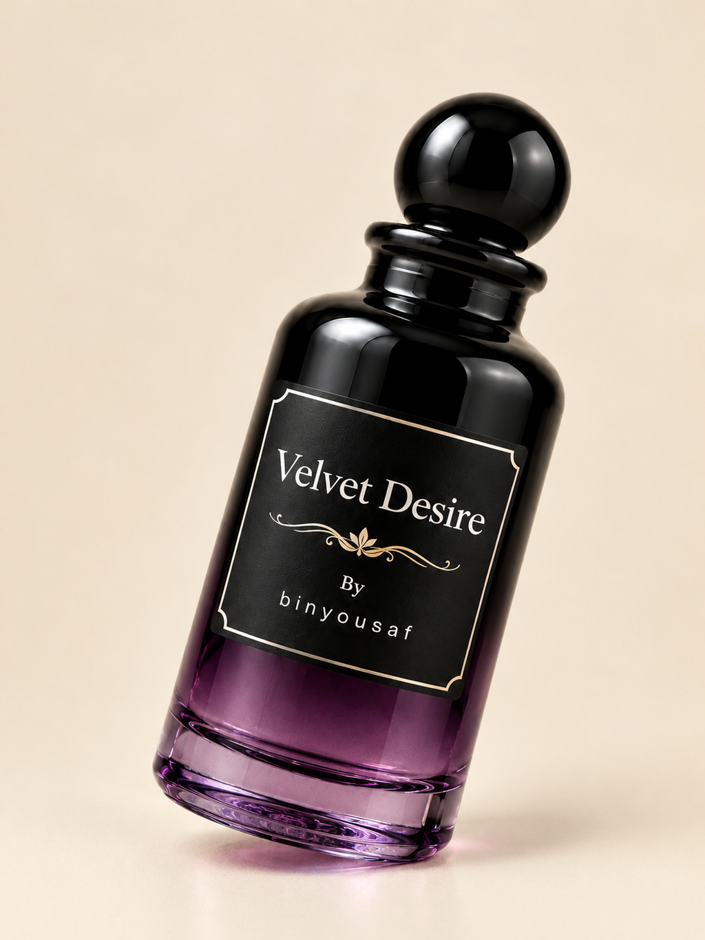 A dark purple to black gradient glass perfume bottle with a black spherical cap and a black label reading 'Velvet Desire By binyousaf' on a warm beige background.