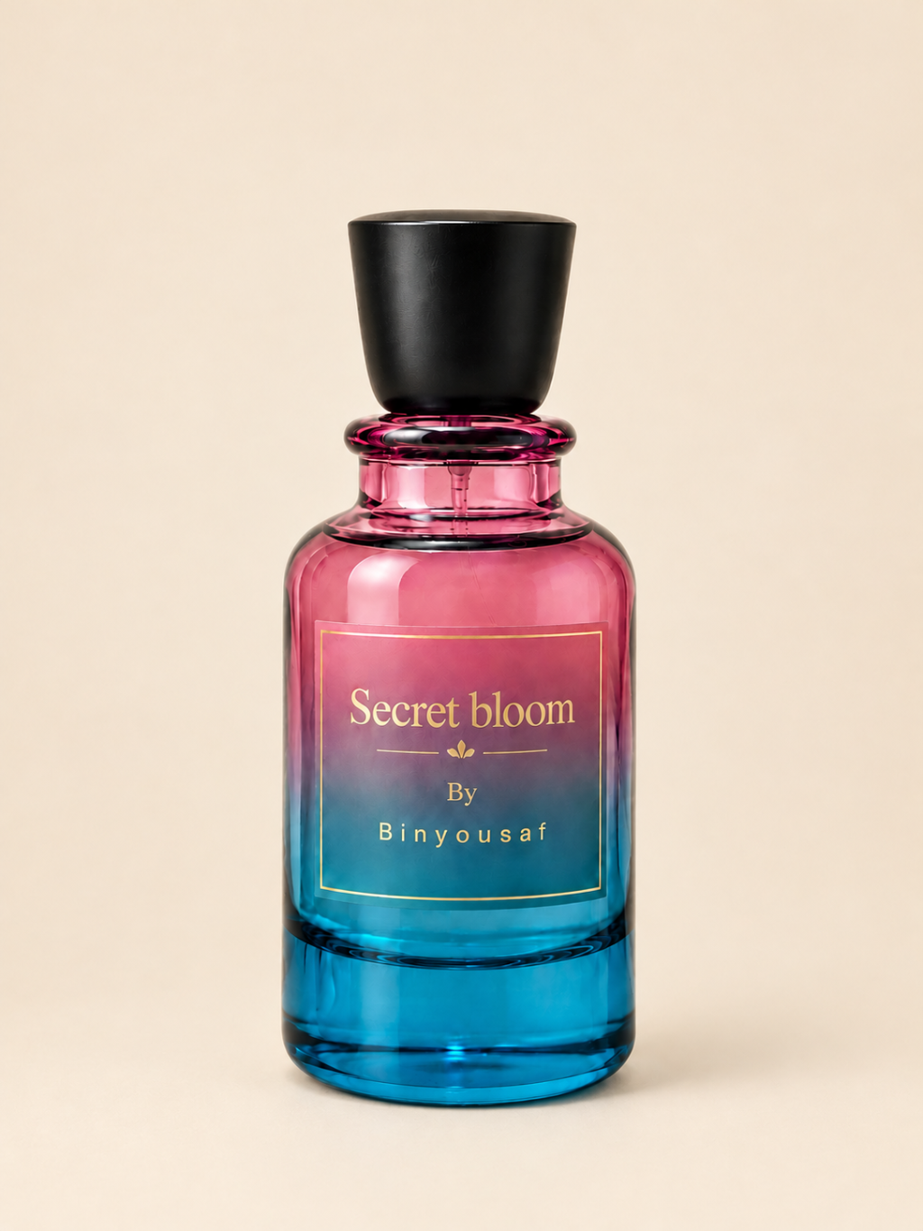A glass perfume bottle with a black cap, featuring a pink-to-blue gradient body and a gold label that reads 'Secret bloom By Binyousaf', set against a solid beige background.